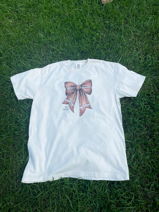 Watercolor Football Bow Graphic Tee. Ivory Comfort Color Crew Neck.