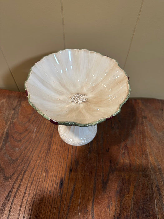 Vintage Christmas Pedestal Dish. It features Holly & Berries around the edge and says “Peace” in the center of Bowl