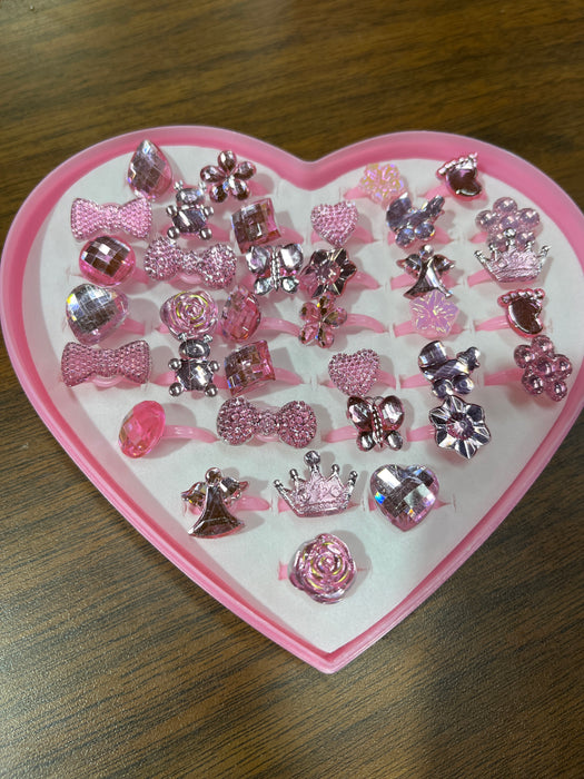 Assorted Pink Rings in Heart Box. Many styles including Bows, Butterflies, Hearts, and More!