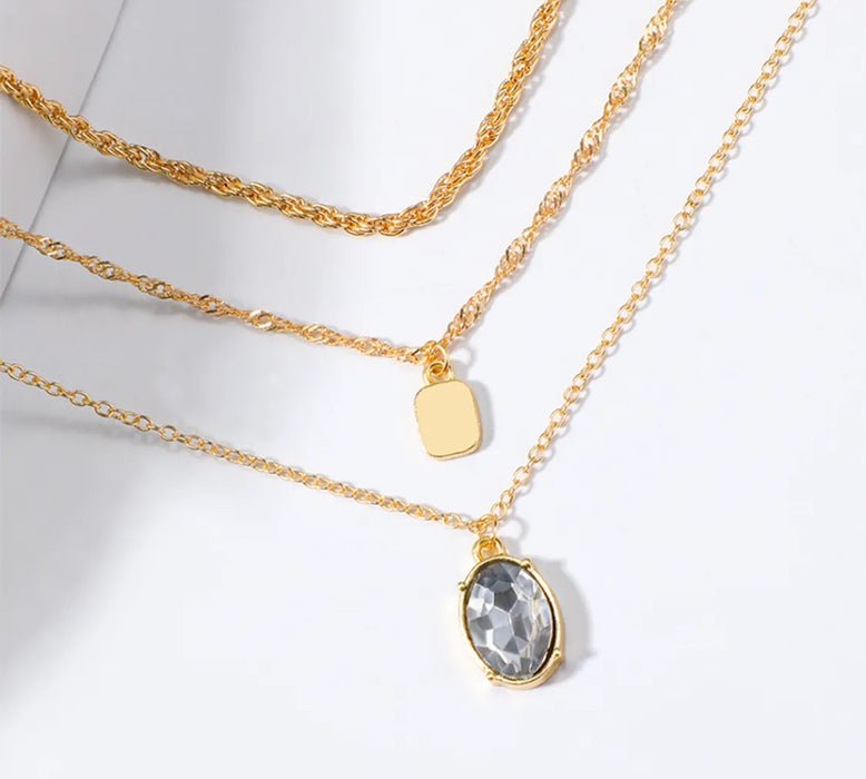 3 Gold Chain Layering Necklaces in One Necklace. Plain Gold Chain, Gold Chain with Square Disc, Gold Chain with Oval Pendant.